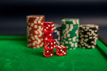 playing cards,dices and poker chips on green poker table