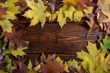Autumn leaves on wooden table background Frame of autumn
