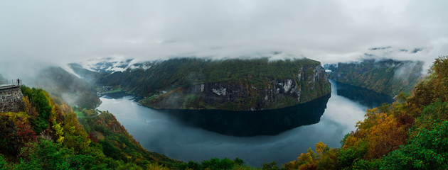 Scenic Aerial Panorama of Mountains and Ocean from Eagles Bend Viewpoint in Geirangerfjord Norway with Clouds