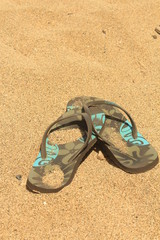 Fototapeta na wymiar Flip-Flop sulla sabbia, estate al mare