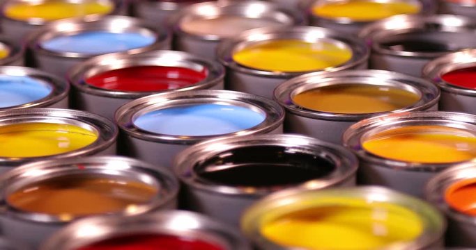 Buckets full of rainbow colored oil paint