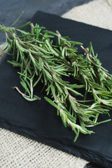 Close up of rosemary on a slate tray. 