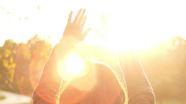 Woman hands touching the sunlight