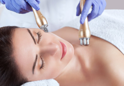 Portrait of woman getting rf-lifting on face and neck. Rf lifting procedure in a beauty parlour.