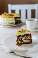 Slice of carrot cake on a wooden table