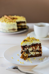 Slice of carrot cake on a wooden table