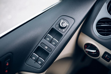 Obraz na płótnie Canvas Mirror control knob in a modern car. Auto window button control inside driver place.