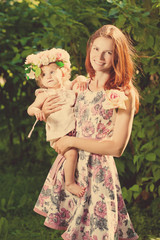 Obraz premium Beauty Mom and baby outdoors. Happy family playing in nature. Mom and baby. Mother and child.
