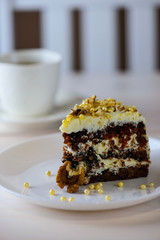 Slice of carrot cake on a wooden table