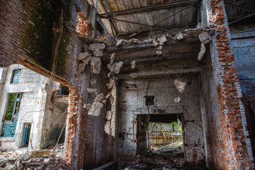 Abandoned and ruined industrial factory building after earthquake disaster or war
