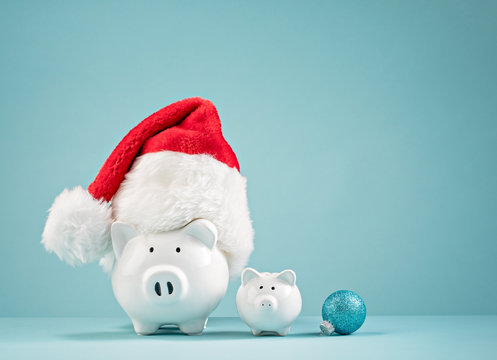 Christmas finances piggy bank wearing santa hat