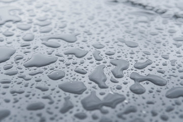 Natural water drops on a glass table after rain.