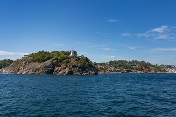 Fototapeta na wymiar Rocky archipelago hills with a lighthouse 