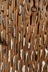 Fototapeta premium Perforated wooden surface with stones