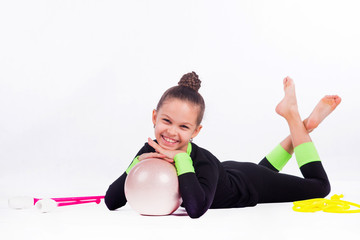Teenager girl doing rhythmic gymnastics exercises on white background
