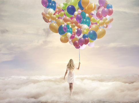 Conceptual picture of a woman holding hundreds of balloons