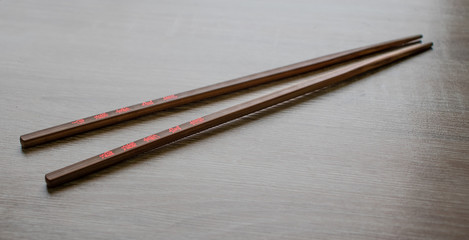 Brown sticks with red hieroglyphs for Oriental food.