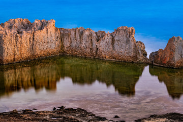 Fototapeta na wymiar A rock and it's reflection on the water - Ayia Napa