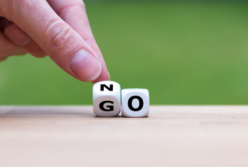 Hand is turning dice and changes the word go to no