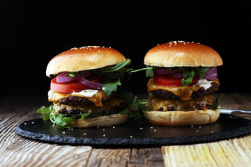 Tasty fresh meat burgers with salad and cheese. Homemade angus burger.