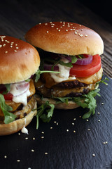 Tasty fresh meat burgers with salad and cheese. Homemade angus burger.