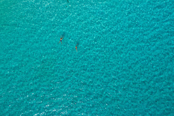 Swimmers from above - a drone shot of sea surface