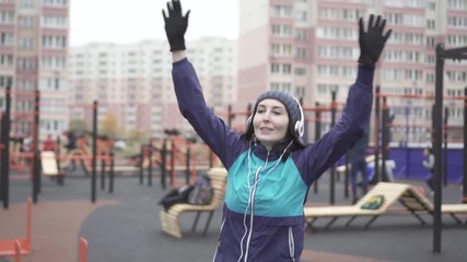 Portrait woman athlete warming up doing exercises on the playground,slow mo