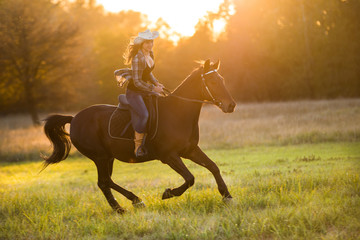 Girl equestrian rider riding a beautiful horse
