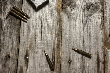Disassembled clip with cartridges 7,92 x 57 - rustic ammos lies on the wooden background