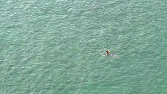 People Swim In Blue Sea
