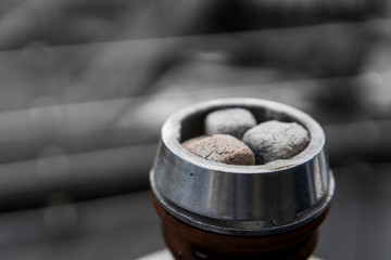 Close-up of a top of hookah with coconut coal.