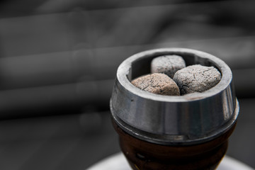 Close-up of a top of hookah with coconut coal.