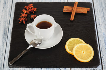 hot tea on black slate square stone