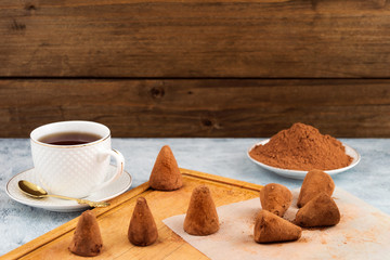 Homemade candy made from chocolate, cocoa powder for sprinkling white mug of tea.