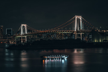 Fototapeta na wymiar The Rainbow Bridge of Tokyo lit up at night. Capital city of Japan