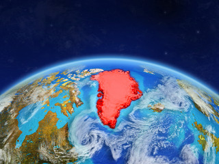 Greenland on planet Earth with country borders and highly detailed planet surface and clouds.