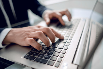 close up. businessman typing on laptop keyboard.