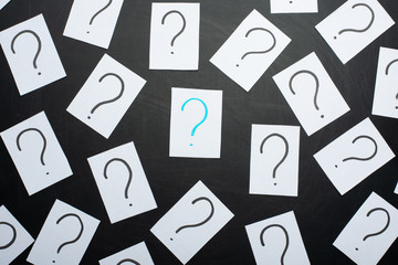 Too Many Questions. Pile of colorful paper notes with question marks. Closeup.