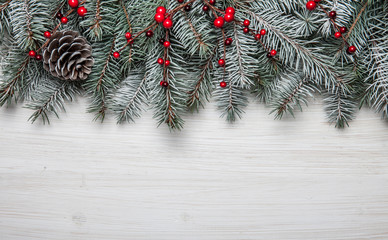 Christmas card. White wooden background with snow fir tree and decoration. Top view with copy space for your text