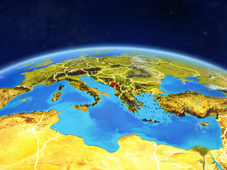 Montenegro on planet Earth with country borders and highly detailed planet surface and clouds.