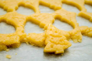 Raw dough for christmas cookies for children, making gingerbread in form of fir tree close-up. Recipe of New year treat. Homemade bakery, xmas sweet, winter holidays concept