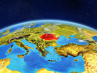 Fototapeta na wymiar Romania on planet Earth with country borders and highly detailed planet surface and clouds.