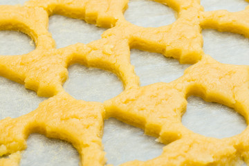 background made of raw dough for christmas cookies for children, making gingerbread in form of ball, fir tree close-up. New year treat. Homemade bakery, xmas sweet, winter holidays concept