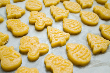 Christmas cookies for children, making gingerbread in form of ball, fir tree, snowman, man. Raw dough. New year treat for Santa Claus cooking. Homemade bakery, xmas sweet, winter holidays concept