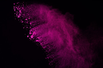 Obraz premium Pink powder explosion on black background. Colored cloud. Colorful dust explode. Paint Holi.