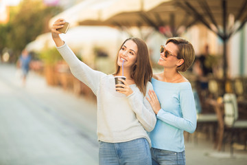 Two beautiful young women taking a selfie