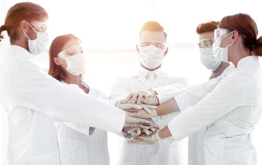 Close-up Photo Of Doctors Stacking Hand With Coworkers