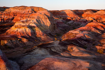 Rainbow City, Wucai Cheng. Colorful Red, Pink, Orange and Yellow landforms in the desert area of Fuyun County - Altay Perfecture, Xinjiang Province Uygur Autonomous Region, China. Rainbow Mountains