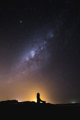 Fototapeta premium silhouette of woman meditation on a night sky