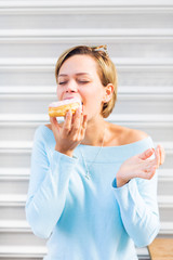 Young woman eating a donut